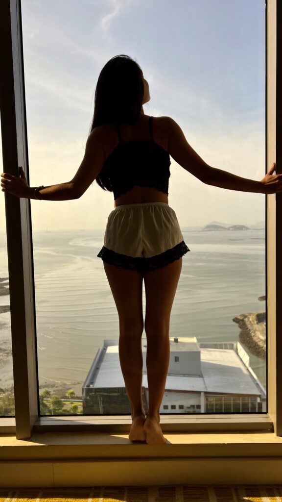 Peruvian Nash Lopez standing in Condo window
